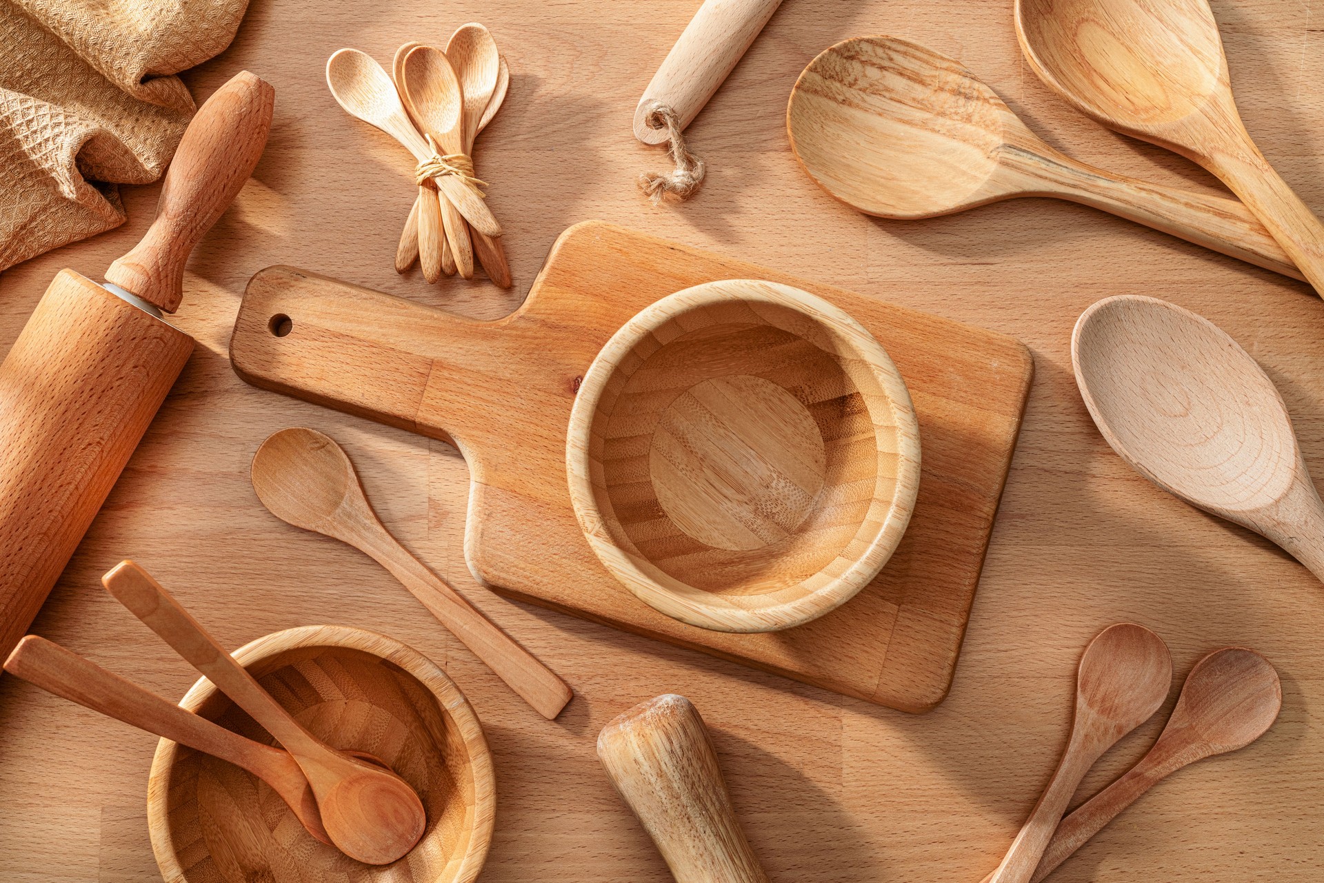 Wooden kitchen utensils composition on rustic wood table